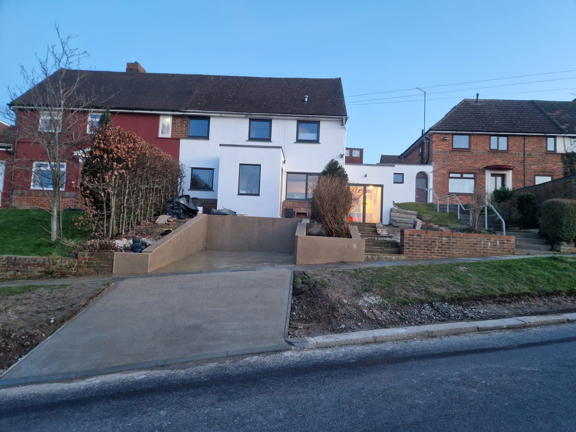 Rendered house & concrete driveway ramp
