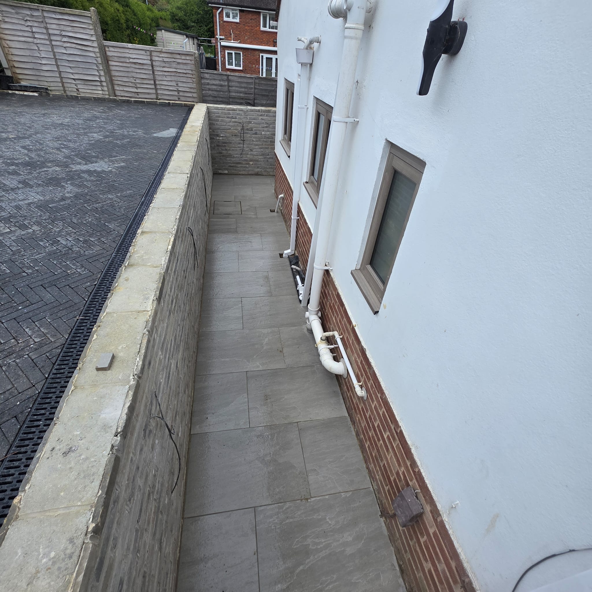 Tiled side path beside a rendered house